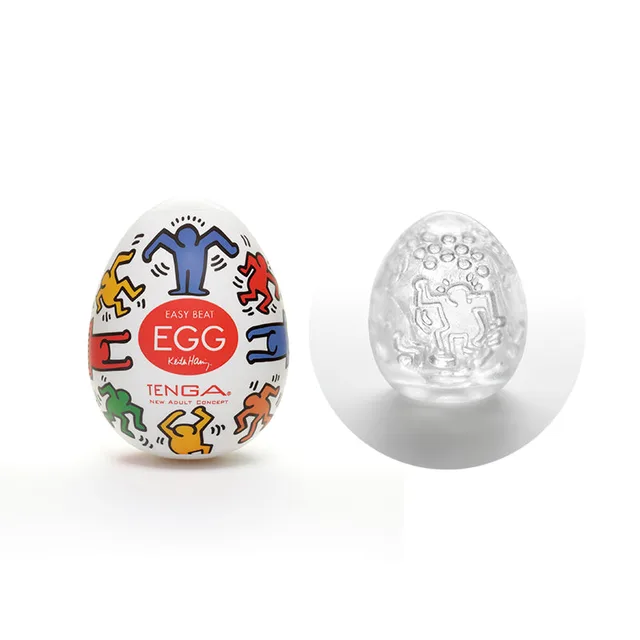 Tenga Keith Haring Dance Egg case beside clear textured sleeve