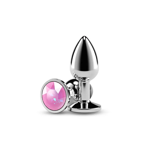 Small polished silver plug beside faceted pink gem base