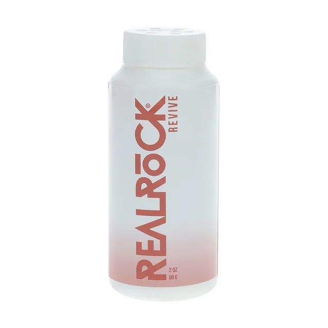 white RealRock Revive powder bottle with red vertical logo and white cap