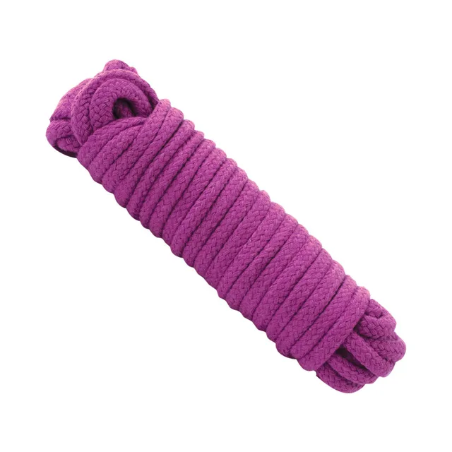 Thick purple cotton bondage rope arranged in a coiled bundle