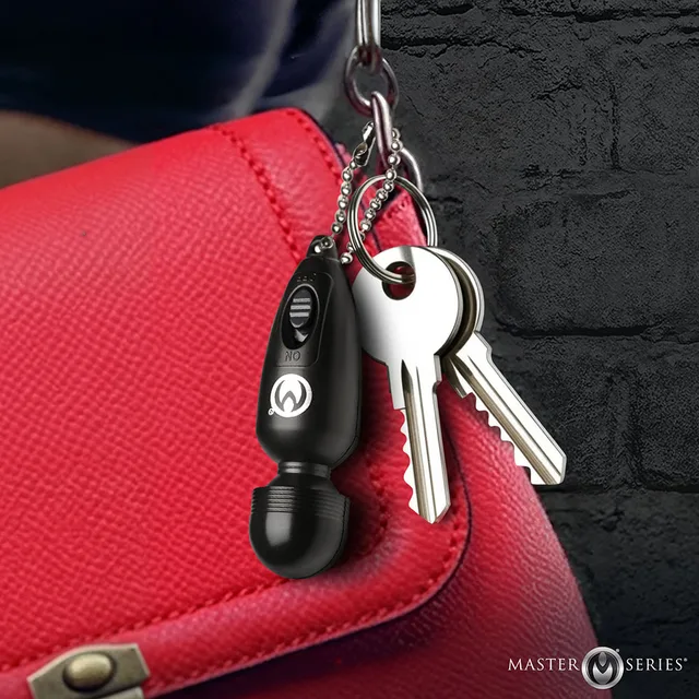 Thunderstick mini wand attached beside keys on a red bag