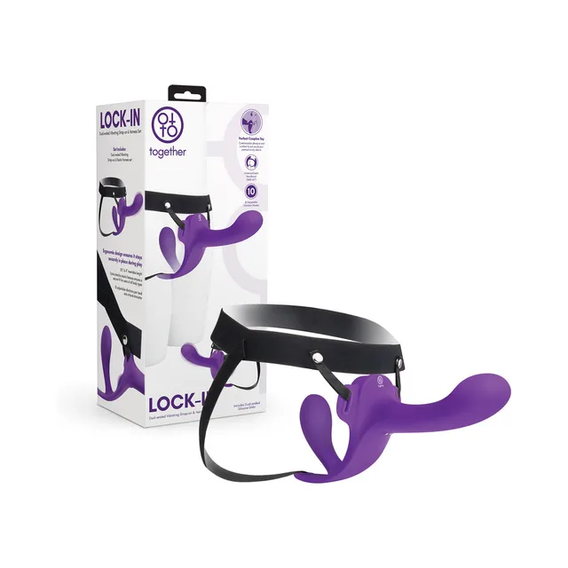 Together Lock-In purple dual-ended vibrator fitted to black adjustable harness beside retail box