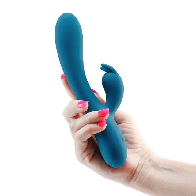 Curved dark teal INYA Luv Bunny dual-arm vibrator held in hand