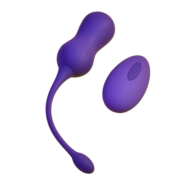 Playboy Double Time purple remote dual Kegel vibrator dual-bulb toy beside oval remote