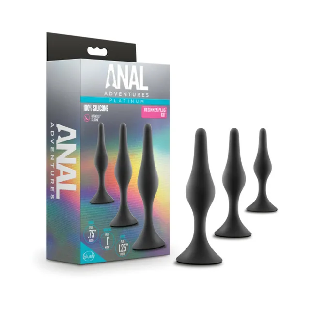 Three black Anal Adventures plugs beside colorful kit package