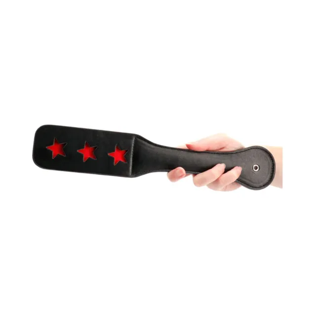 Black Ouch paddle with three red star-shaped cutouts and rounded handle