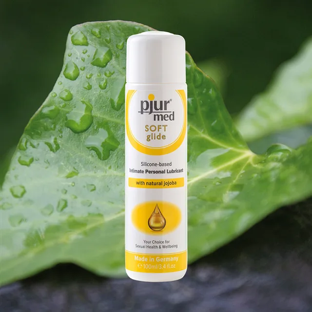 Pjur Med Soft 100 ml Bottle beside green leaf