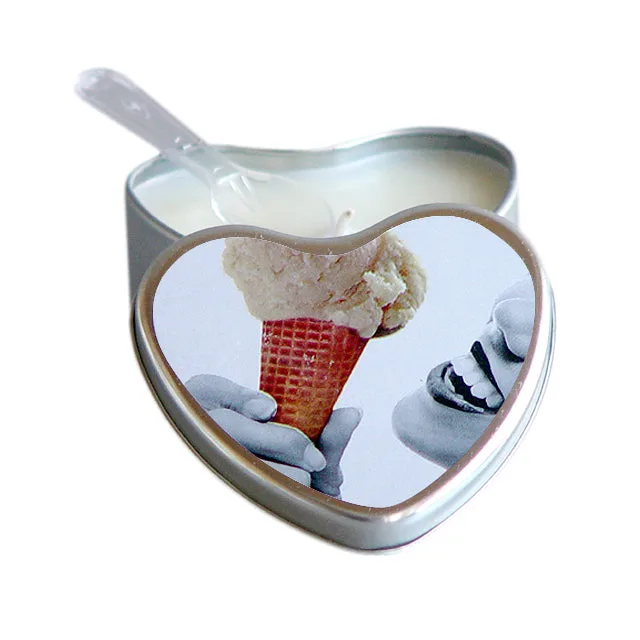 Open heart-shaped silver tin of Earthly Body vanilla massage candle with pouring corner