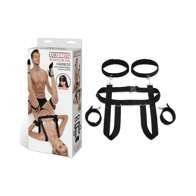 Black Lux Fetish Position Pal harness with two thigh cuffs beside retail box