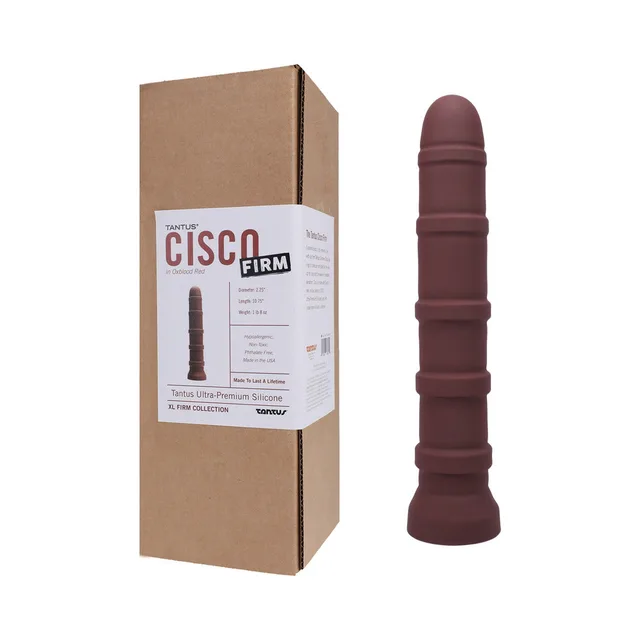 Garnet Tantus Cisco ringed dildo standing beside labeled brown box