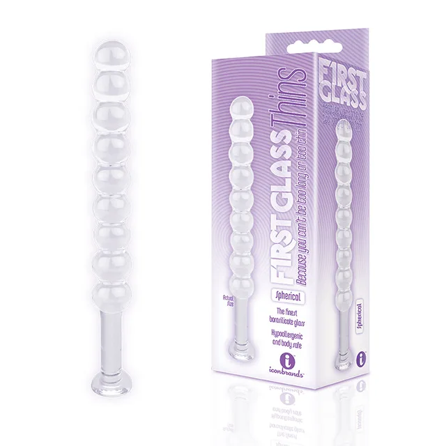 Clear spherical Glass Thins plug with round beads beside purple box