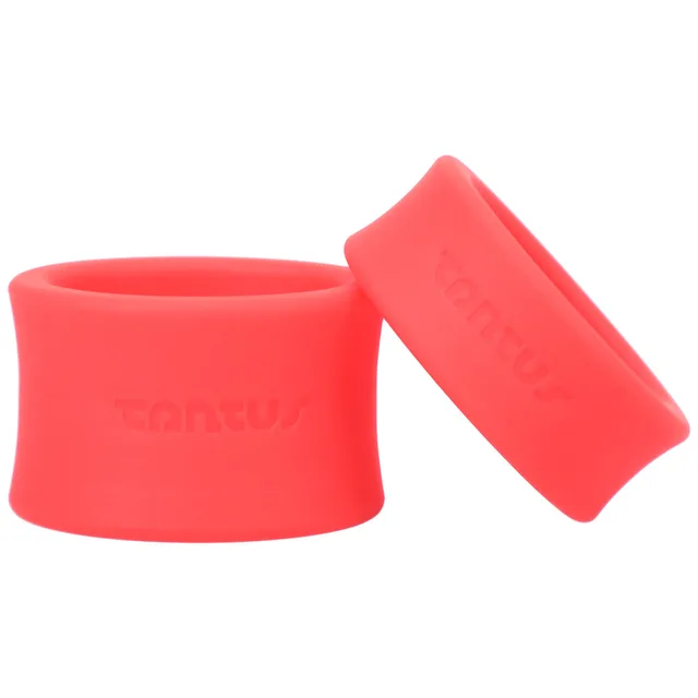 Two red Tantus ball stretcher bands posed upright and angled