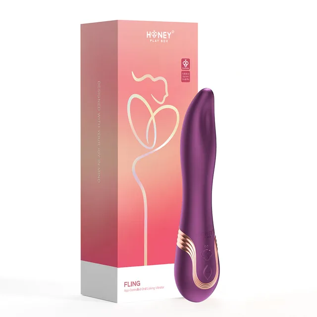 purple Honey Play Box Fling curved vibrator with gold accent beside coral box