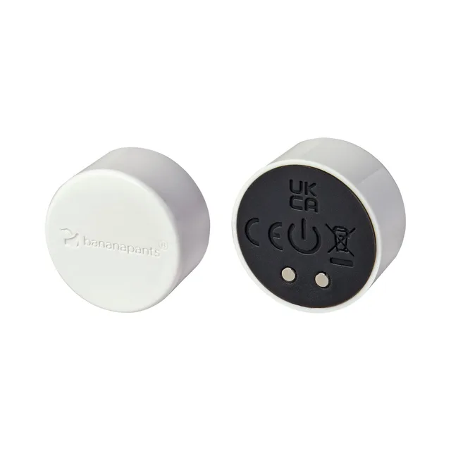Front and rear views of white Puck Vibe with charging contacts
