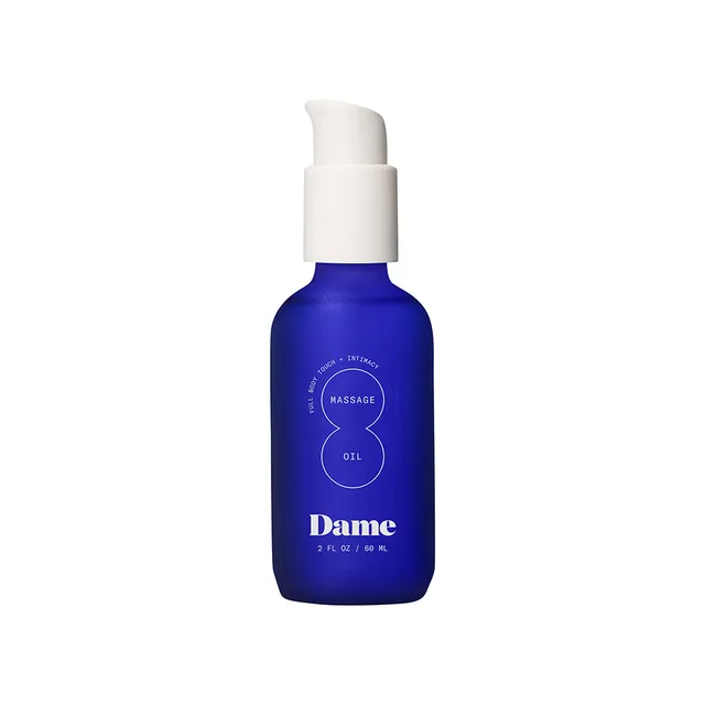 Front view of blue Dame massage oil bottle with white pump