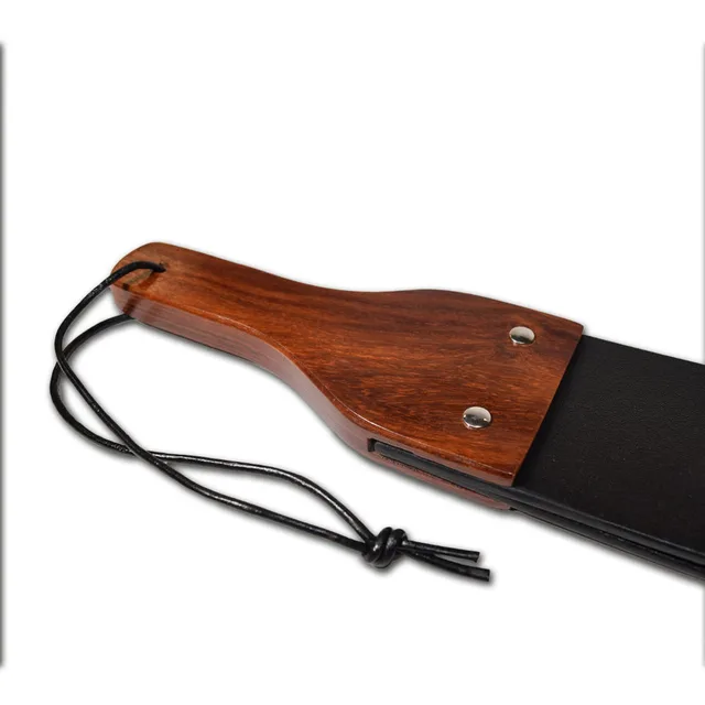 Close-up of brown wood handle and wrist cord on Prowler RED paddle