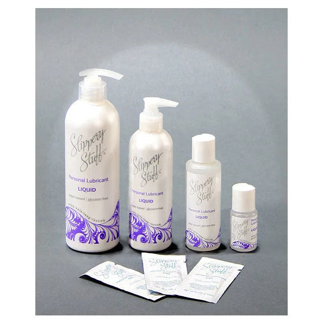 Slippery Stuff Gel bottles and 0.25 oz lubricant packets on gray background