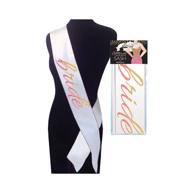 White Glitterati Bride sash with gold and pink script beside retail card
