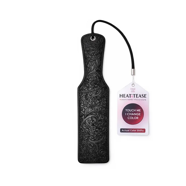 Pink Elephant Heat Tease black and pink flower paddle black embossed floral face beside its product tag