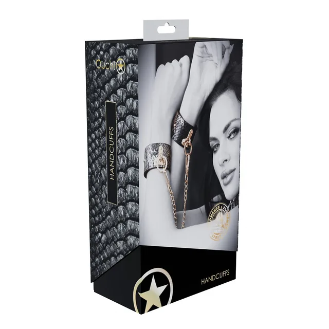 black and silver snakeskin Florence handcuffs with gold chain on box