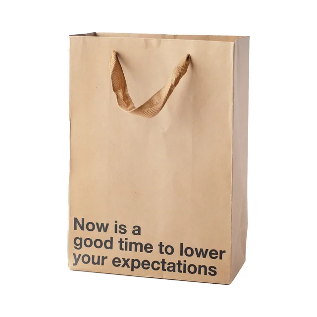 tan kraft gift bag reading Now is a good time to lower your expectations