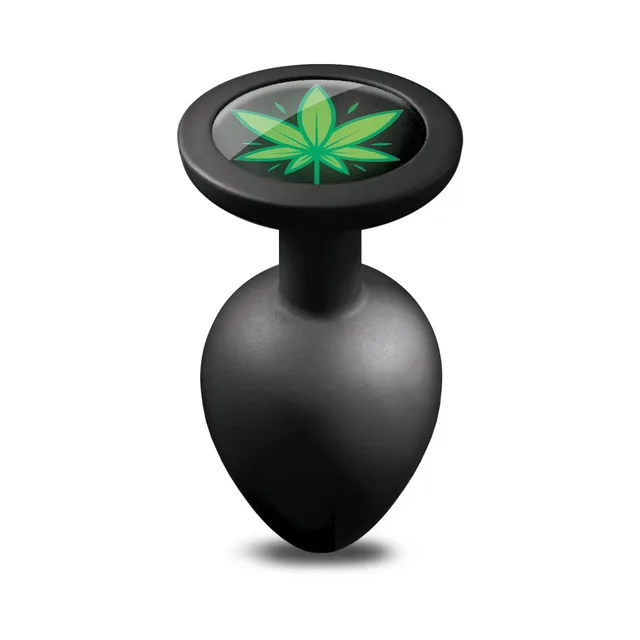 Top view of small black Stoner Vibes plug showing green leaf base medallion