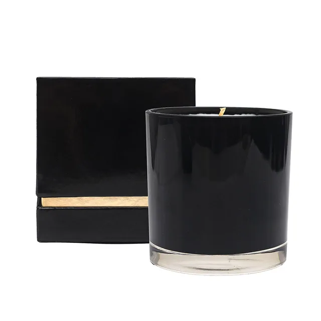 black glass Olivia's Boudoir Nude candle beside a closed gold-trim presentation box