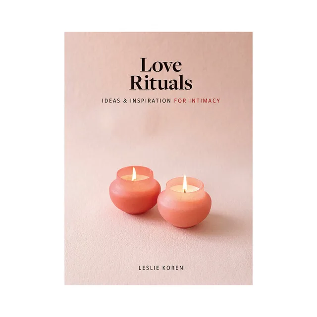 blush pink Love Rituals book cover with two small glowing candles