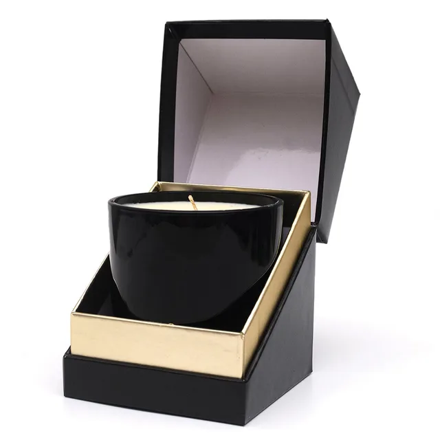 Olivia's Boudoir Nude black massage candle inside an open black and gold box