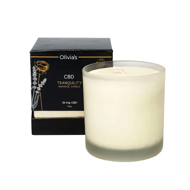 ivory Olivia's Boudoir CBD Tranquility candle beside a black gold-lettered carton