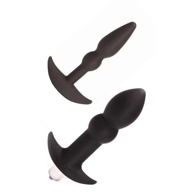 Two black Tantus Perfect plugs with one removable bullet visible