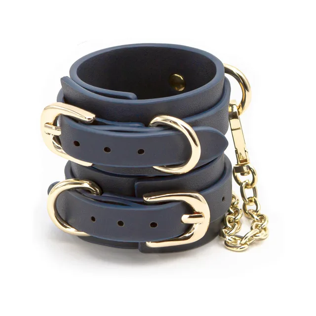 Pair of dark blue buckle cuffs linked by gold chain