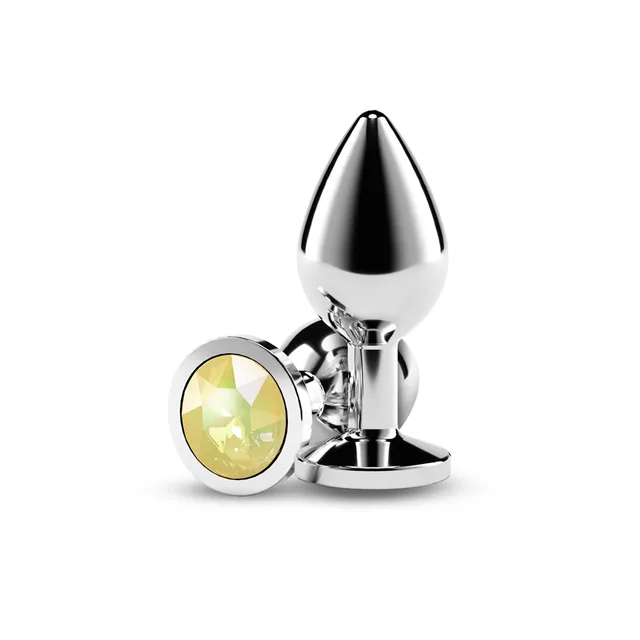 Polished silver medium plug beside round yellow faceted gem