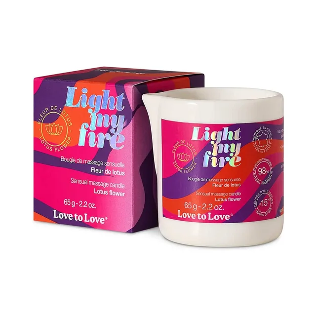 Light My Fire lotus massage candle in white jar beside pink box