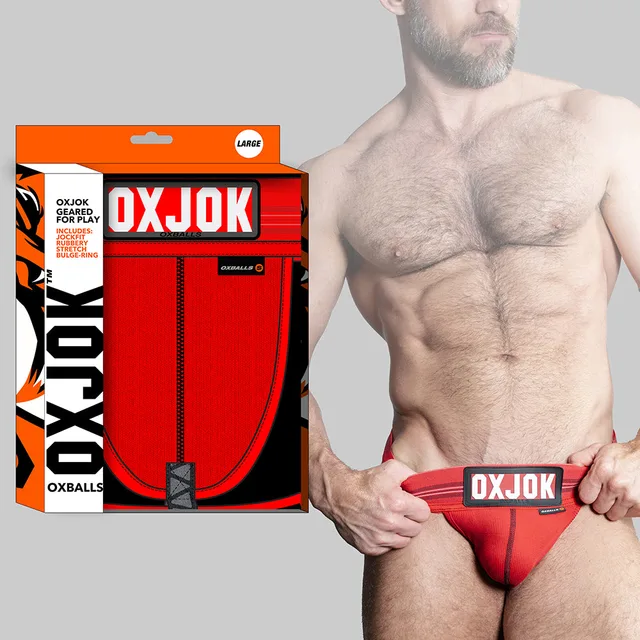 Oxballs Oxjok red jockstrap worn by model beside orange branded box