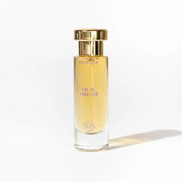 single Lilac Dream glass parfum bottle with gold cap casting a shadow on white
