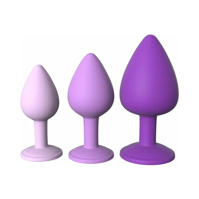 Three graduated purple plugs standing from small to large