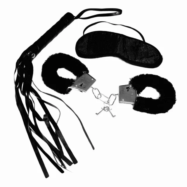 Black multi-tail whip, blindfold, and furry metal handcuffs laid flat