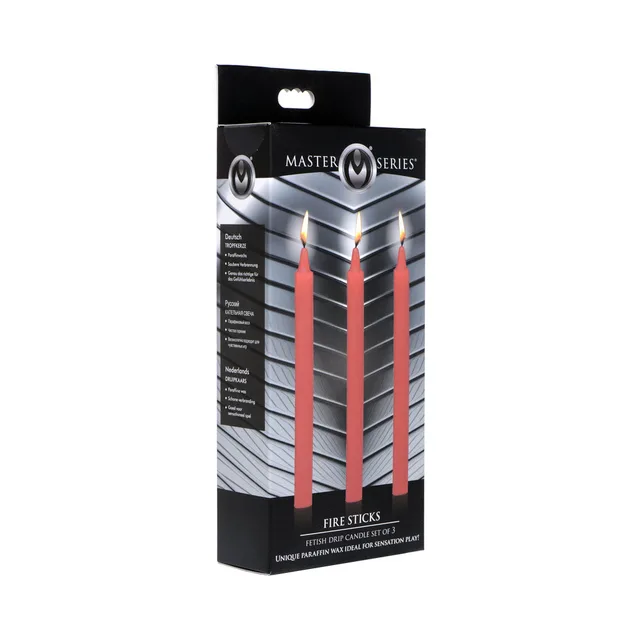 three red Master Series Fire Sticks paraffin candles with lit wicks on box