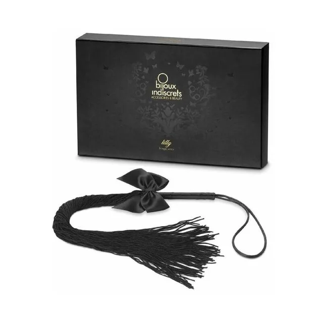black Lilly fringe whip with satin bow loop handle and long tassels beside presentation box