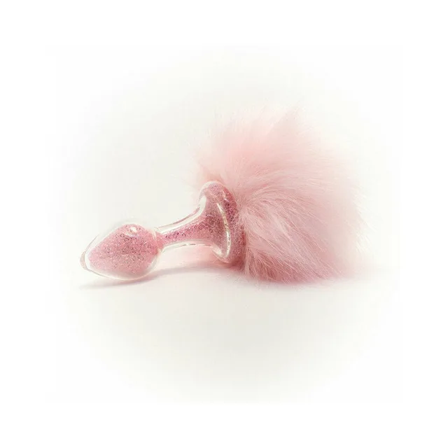 light-pink magnetic tail beside glitter-filled pink glass plug
