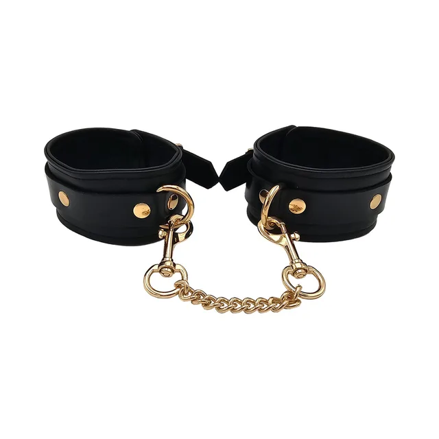 Rouge black leather ankle cuffs with gold hardware front paired view with connecting chain