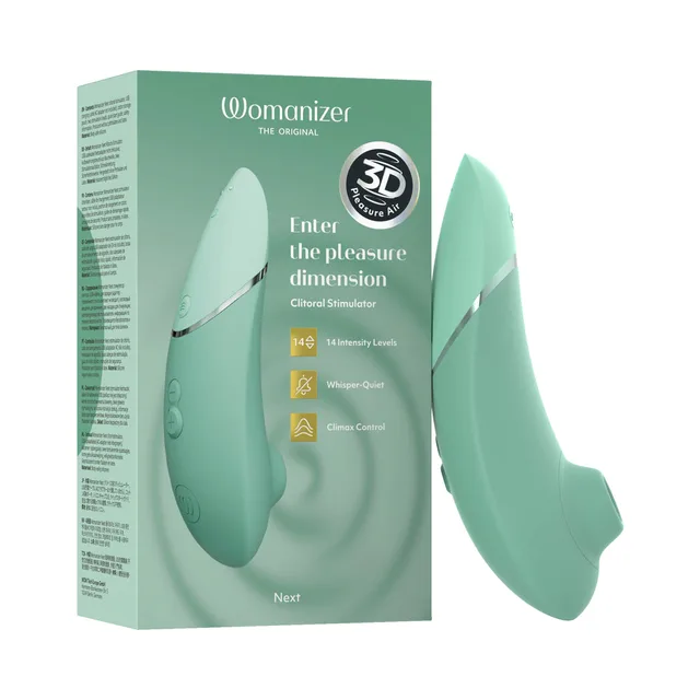 sage-green Womanizer Next curved air stimulator beside its pale green retail box