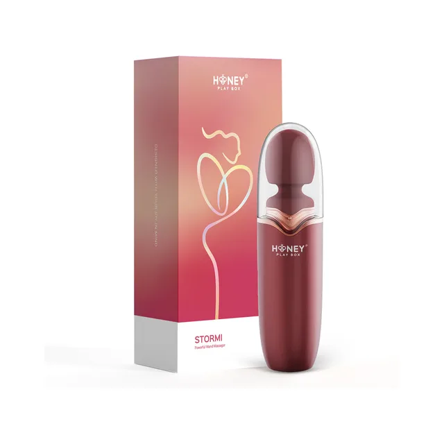 burgundy Honey Play Box Stormi wand inside white charging case beside coral box