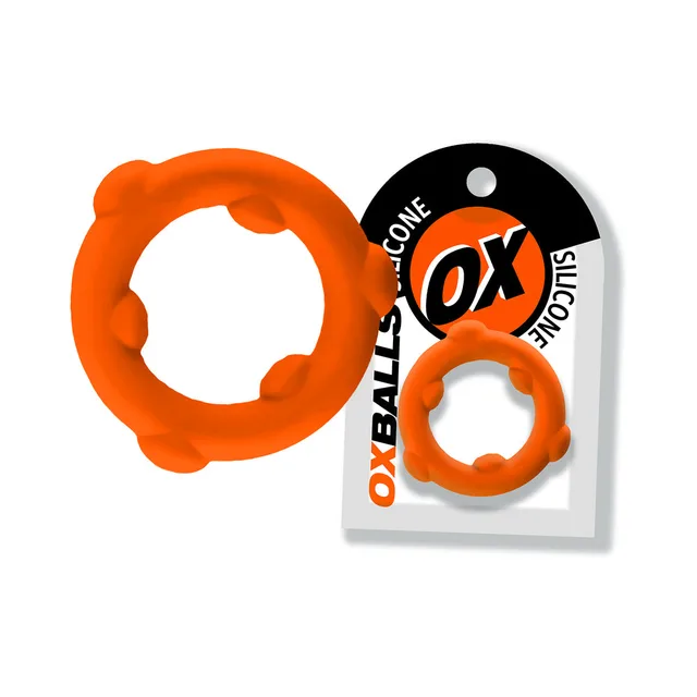 Orange Oxballs Spinner ring with six raised nodes beside card