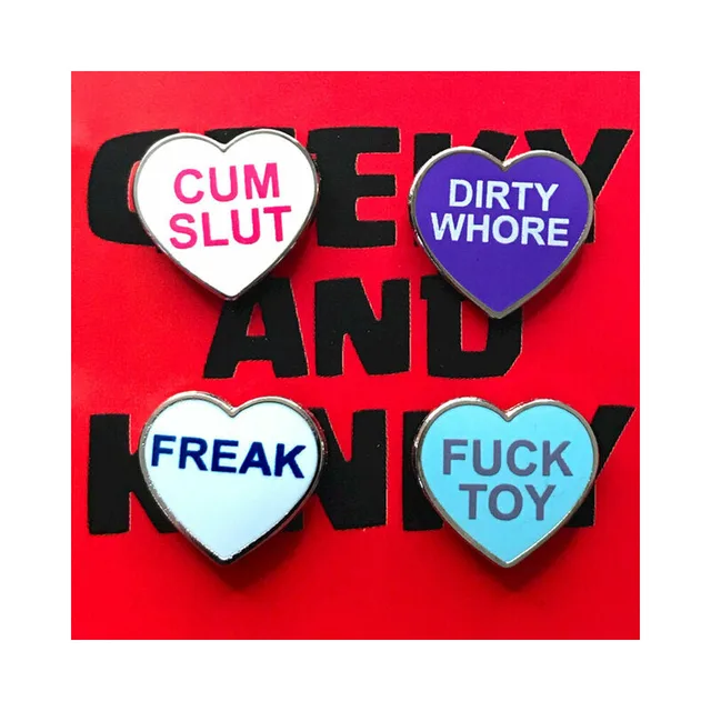 four heart enamel pins with Cum Slut Dirty Whore Freak and Fuck Toy text