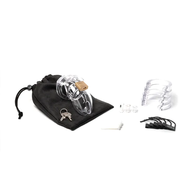 CB-X CB-6000S Clear Chastity Cage kit beside black storage pouch keys and spacers