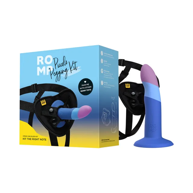 ROMP Piccolo multicolor curved dildo mounted in black adjustable harness beside box