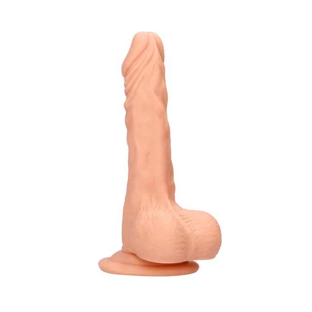 Angled beige seven-inch RealRock dildo with balls and suction base
