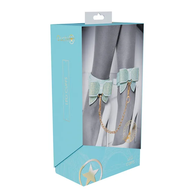 blue Paris Collection bow leg cuffs and gold chain shown on aqua box